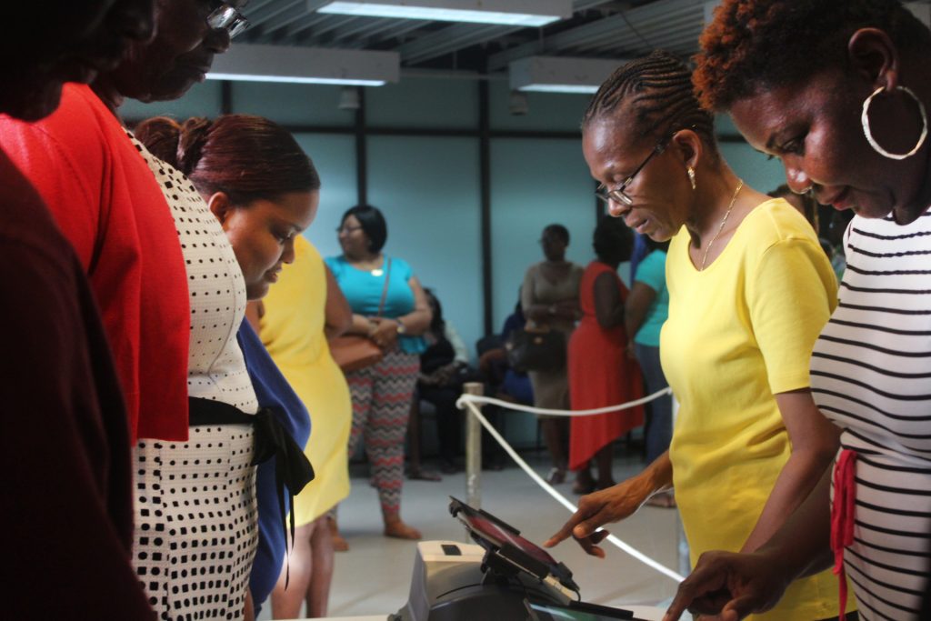 Voters sign in on electronic devices, introduced to the British Virgin Islands for the first time.