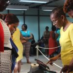 Voters sign in on electronic devices, introduced to the British Virgin Islands for the first time.