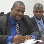 two men signing a contract