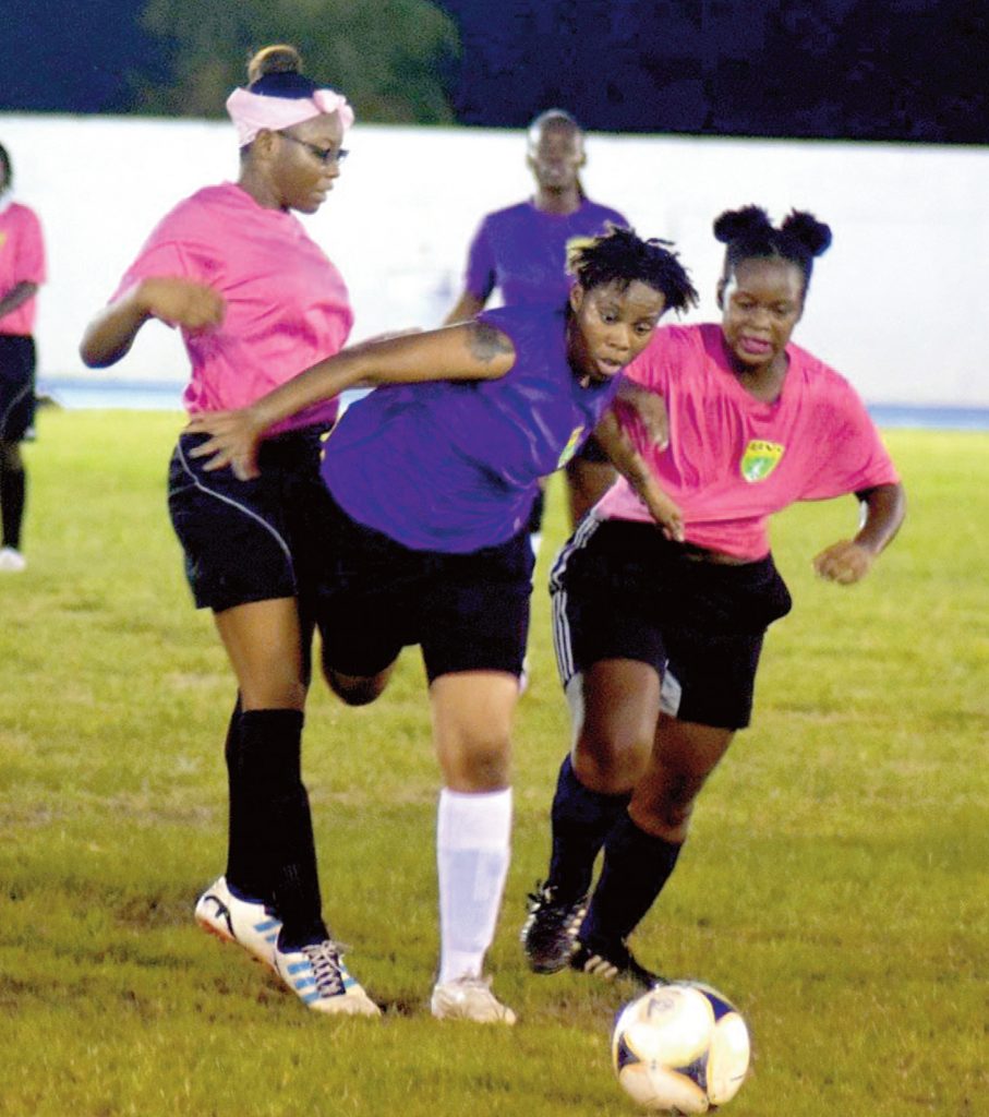 Sapphire Flax fights her way through two defenders during a match between Ballstars and VG United prior to the start of the women’s league on Oct. 31. (Photo: BVIFA)
